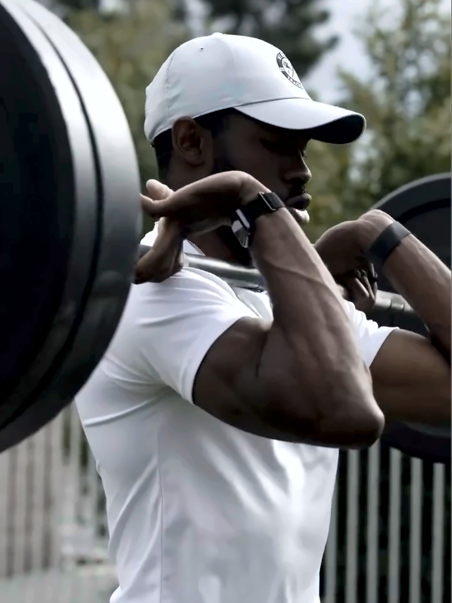 Michael Ohioze front-racking a barbell during a training session